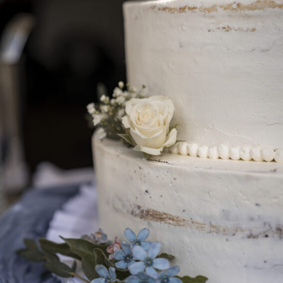 Detailaufnahme einer Hochzeitstorte mit Blumen